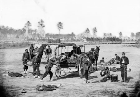 American Zouave ambulance crew removing wounded soldiers during the Civil War.