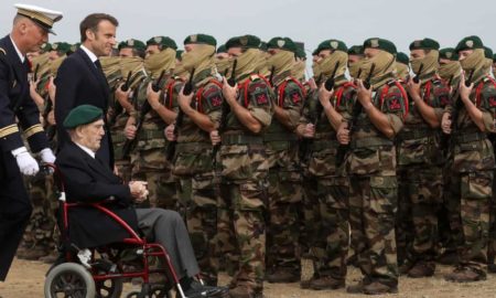 Accompanied by Emmanuel Macron , Léon Gautier attends the D-Day ceremony at Colleville-Montgomery.