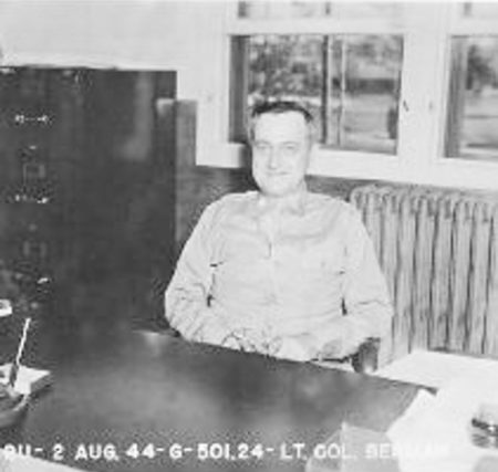 Lt. Col. William Berman, Station Executive Officer, seated at his desk.
