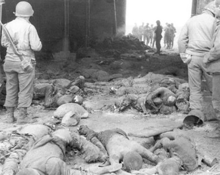 U.S. soldiers viewing the burned corpses inside the barn at Gardelegen. One of the corpses was mistakenly identified as Johnny Nicholas.