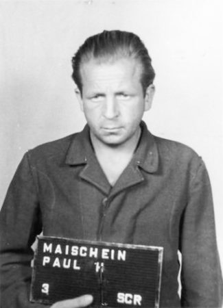Former SS-Rottenführer Paul Maischein (1912−1988), a guard and medical orderly at Rottleberode. Mug shot taken at the time of his arrest for war crimes. Found guilty, he was sentenced to five years. Photo by anonymous (c. June 1947). PD-U.S. Government. Wikimedia Commons.