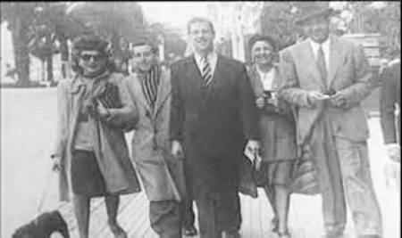 Johnny Nicholas (far right) with some of his friends in the film industry walking in Paris. Vivian Romance (1912−1991) is reportedly the woman on the far left with the dog.