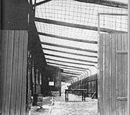 KZ Sachsenhausen barracks 18 & 19. Note the barbed wire netting between the roofs. Photo by anonymous-unable to determine owner (c. 1945). Columbia College Today, May/June 2007. “The Improbable Tale of Krueger’s Men.” https://www.college.columbia.edu/cct_archive/may_june07/features2.html