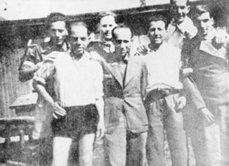 Seven inmates of “Operation Bernhard” pose shortly after their liberation. Adolf Burger is in the back row, far left and Max Groen is in the front row, far right.
