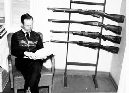 Simo Häyhä in retirement seated next to some of his hunting guns. Photo by anonymous (date unknown). Daily Mail. Rory Tingle, “The White Death,” 6 December 2017. https://www.dailymail.co.uk/news/article-5148231/How-five=foot-farmer-deadliest-sniper-history.html