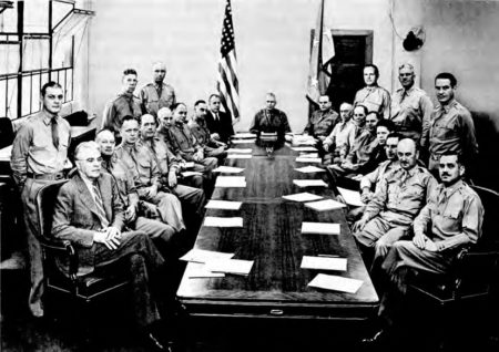 Weekly staff meeting at Services of Supply headquarters. Gen. Clay is seated, seventh from left. Photo by anonymous (c. June 1942). PD-U.S. government. Wikimedia Commons.