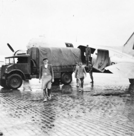 A Douglas Dakota C4 being unloaded by German civilian workers at Gatow Airport during the early weeks of the Berlin Airlift. Photo by anonymous (c. 1948). Imperial War Museum. PD-Photograph taken before 1 June 1957. Wikimedia Commons.