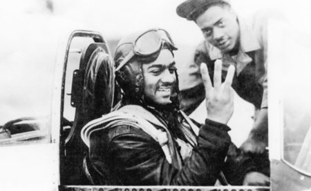 Harry Stewart Jr. in the cockpit of his fighter indicating the three “kills” he had in a single day. Photo by anonymous. (date unknown). U.S. Air Force. PD-U.S. Government.
