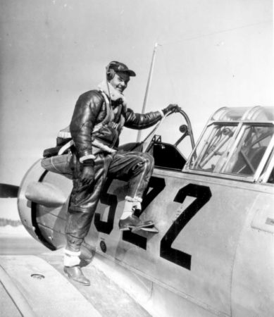 Capt. Benjamin O. Davis Jr. climbing into an advanced trainer at Tuskegee. Photo by anonymous (c. January 1942). Office of War Information. PD-U.S. Government.