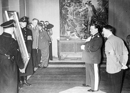 Reichsmarschall Hermann Göring inspecting the painting he has “gifted” to Adolf Hitler. Photo by anonymous (date unknown). PD-CCA-Share Alike 3.0 Germany. Wikimedia Commons.