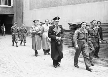 Three senior Nazi officers after their capture in Flensburg, Germany. Adm. Karl Dönitz (center) is followed by Gen. Alfred Jodl (left) and Albert Speer (right). The men in the photo are not 30AU. However, about thirty 30AU men were present at the surrender and participated in the capture and surrender of other German admirals. Photo by anonymous (c. 23 May 1945). Imperial War Museum. War Office Second World War Official Collection. PD-Image published before 1974. Wikimedia Commons.