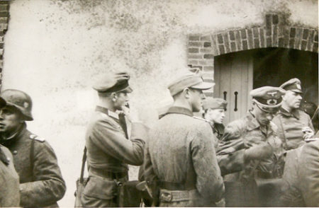 German Naval sub-headquarters captured by AU30 with staff officers surrendering. Photo by anonymous (26 June 1944). National Archives. Courtesy of Guy Allan Farrin. “30 [Commando] Assault Unit” (www.30au.co.uk).