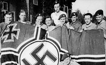 30 AU posing with a captured German flag. Photo by anonymous (date unknown). Courtesy of Littlehampton Museum.