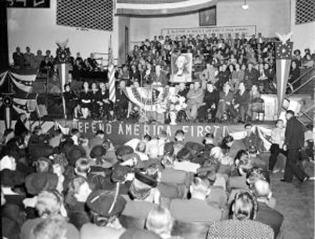 Charles Lindbergh addresses a Des Moines rally for America First Committee. America First was a prominent isolationist organization and its members were prominent businesspeople, politicians, future presidents, and others. It was accused of being antisemitic and pro-fascist. Photo by anonymous (5 October 1941). PD-Copyright owner release. Wikimedia Commons.