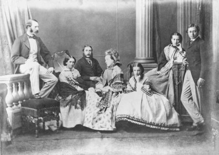 Group photograph taken for the occasion of the engagement between Albert Edward, Prince of Wales, later King Edward VII to Princess Alexandra of Denmark, later Princess of Wales and Queen Alexandra. Members of the Princess Alexandra’s family include Prince Christian of Denmark, later King Christian IX (far left). Photo by Ghémar Fréres studio (c. September 1862). PD-Published before 1 January 1929. Wikimedia Commons.