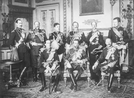 Nine European sovereigns at Windsor for the funeral of King Edward VII. King Haakon VII of Norway is standing far left while King Frederik VIII of Denmark is seated far right. Photo by W. & D. Downey (20 May 1910). PD-Author’s life plus 70 years or fewer. Wikimedia Commons.