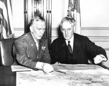 Gen. George C. Marshall (left) and Henry Stimson (right) conferring over a map. Marshall and Stimson formed a close working relationship during and after World War II. Photo by anonymous (c. 1942). PD-U.S. government. Wikimedia Commons.