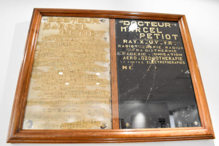 Original exterior plaques used by Dr. Petiot at 66, rue de Caumartin to identify his medical office. Photo by Sandy Ross (c. September 2022). Paris Police Museum.
