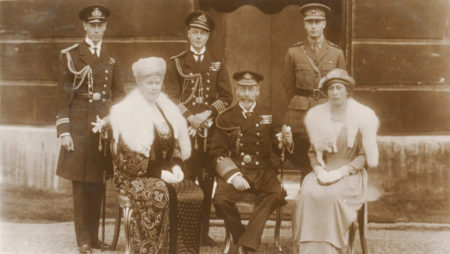 Group portrait of the British royal family: Sitting, left to right: Queen Mary of Teck, King George V, and Mary, Princess Royal. Standing, left to right: Prince Albert Duke of York (future King George VI), Edward Prince of Wales (future King Edward VIII), and Prince Henry Duke of Gloucester. Photo by Vandyk photographic studio (c. 1921). PD-Published before 1 January 1929. Wikimedia Commons.