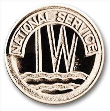 National Service Inland Waterways badge that was worn by the women volunteers on their clothing. The “IW” became the basis of their nickname, “Idle Women.” Photo by anonymous (c. 1942). U.K. Government Artistic Works.
