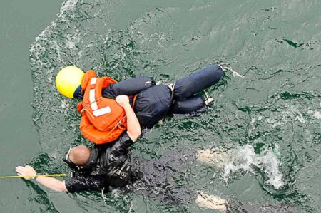 U.S. Navy Seaman Matthew Honan recovers Oscar, a mannequin, during a “man overboard” drill. Photo by Mass Communication Specialist 3rd Class Matthew R. Cole (17 May 2011). PD-U.S. government. Wikimedia Commons.