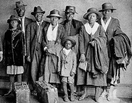 Scott and Violet Arthur arrive with their family at Chicago’s Polk Street Depot, two months after their two sons were lynched in Paris, Texas. This image became an iconic symbol of the Great Migration. Photo by anonymous (30 August 1920). Originally published by The Chicago Defender on 4 September 1920. PD-Published before 1 January 1929. Wikimedia Commons.