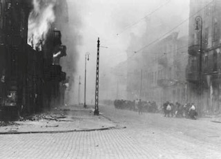 Photograph from the Stroop Report showing the destruction by fire of the Warsaw Ghetto. Photo by anonymous (c. April-May 1943). National Archives and Records Administration, College Park, MD.