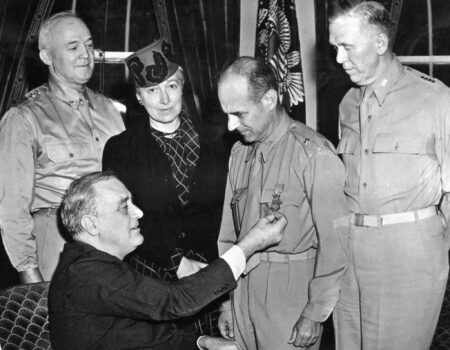 Brigadier General James H. Doolittle shown receiving the Medal of Honor from President Franklin D. Roosevelt. Looking on (left to right) are Gen. “Hap” Arnold, chief of USAAF, President Roosevelt (seated), Mrs. Doolittle, Gen. Doolittle, and Gen. George C. Marshall, chief of staff. Photo by anonymous (c. May 1942). National Museum of the U.S. Navy. PD-U.S. Government (Wikimedia Commons).