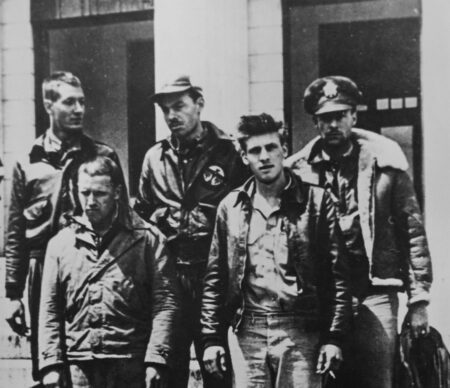 Crew No. 16 after their capture on 20 April 1942 by the Imperial Japanese Army at Nanchang, China. Top, left to right: Lt. William Farrow, pilot; Lt. George Barr, navigator; Lt. Robert Hite, copilot. Bottom, left to right: Cpl. Jacob DeShazer, bombardier; Sgt. Harold Spatz, engineer/gunner. Farrow and Spatz were executed by the Japanese. The others were imprisoned and released via liberation in August 1945. Phot by anonymous (c. 20 April 1942). PD-Expired copyright. Wikimedia Commons.