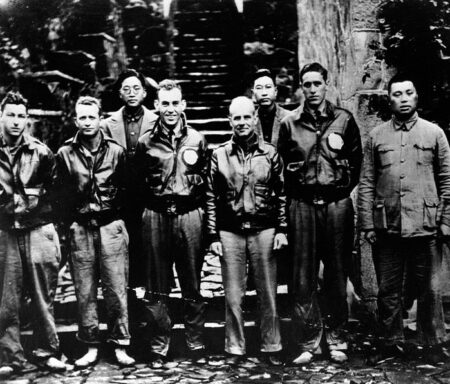 Survivors of the Doolittle Raid in China after the raid. Left to right: SSgt. Fred Braemer, SSgt. Paul Leonard, Gen. Ho (director of the Branch Government of Western Chekiang Province), Lt. Richard Cole, Lt. Col. Doolittle, Henry Shen (Bank manager), Lt. Henry Potter, Chao Foo Ki (secretary of the Western Chekiang Province Branch Government). Photo by anonymous (c. April 1942). Naval Historical Center. PD-U.S. Government. Wikimedia Commons.