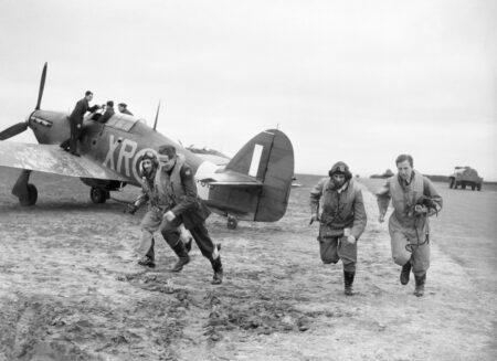American pilots of No. 71 “Eagle Squadron” rush to their Hawker Hurricanes at RAF Kirton-in-Lindsey. Photo by anonymous (17 May 1941). Imperial War Museum. PD-U.K. Government public domain. Wikimedia Commons.